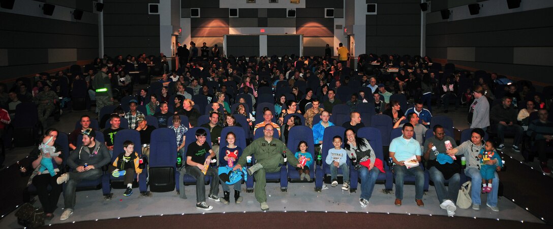 Members of the 27th Special Operations Wing find their seats prior to the showing of a movie at the grand reopening of the Cannon Theater Jan. 31, 2014 at Cannon Air Force Base, N.M. The theater, which closed in early 2013 due to funding issues, was able to reopen as a result of the Navy DVD Program. (U.S. Air Force photo/Senior Airman Whitney Tucker)