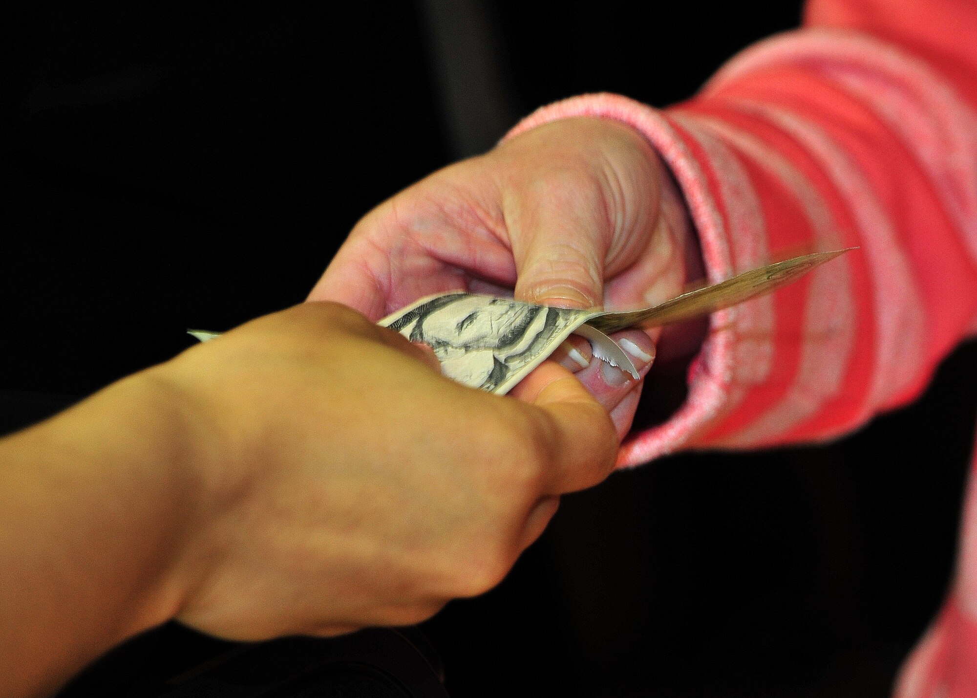 A member of the 27th Special Operations Force Support Squadron returns change to a concession stand customer at the grand reopening of the Cannon Theater Jan. 31, 2014 at Cannon Air Force Base, N.M. The theater, which closed in early 2013 due to funding issues, was able to reopen as a result of the Navy DVD Program. (U.S. Air Force photo/Senior Airman Whitney Tucker)