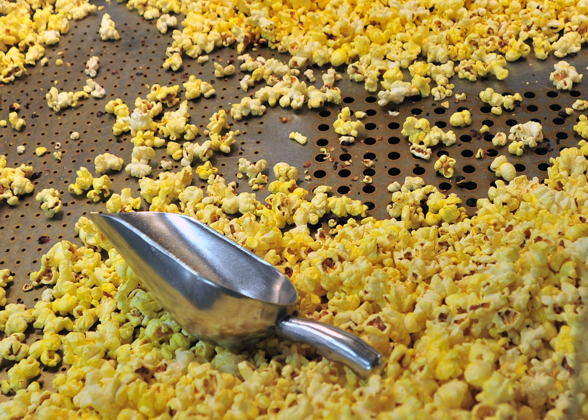 Freshly popped popcorn is ready to go at the grand reopening of the Cannon Theater Jan. 31, 2014 at Cannon Air Force Base, N.M. The theater, which closed in early 2013 due to funding issues, was able to reopen as a result of the Navy DVD Program. (U.S. Air Force photo/Senior Airman Whitney Tucker)