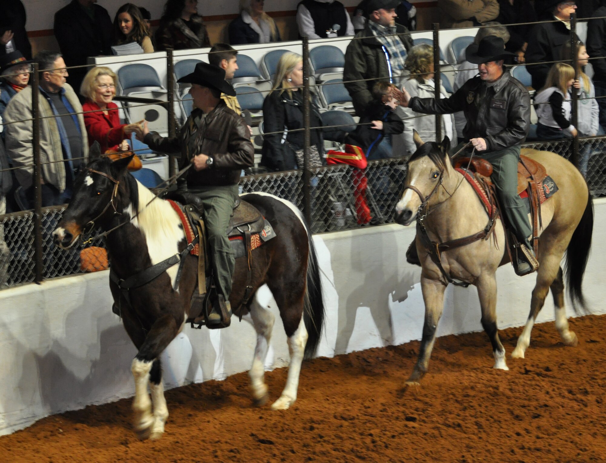 It was an exciting day at Fort Worth Stock Show and Rodeo's Military Appreciation Day. Col. John Breazeale, 301st Fighter Wing commander, Col. Chris Yancy, 301st FW vice commander, rode in the grand entry prior to enjoying the sights and sounds of this historic annual event. (U.S. Air Force photo/Master Sgt. Julie Briden-Garcia)