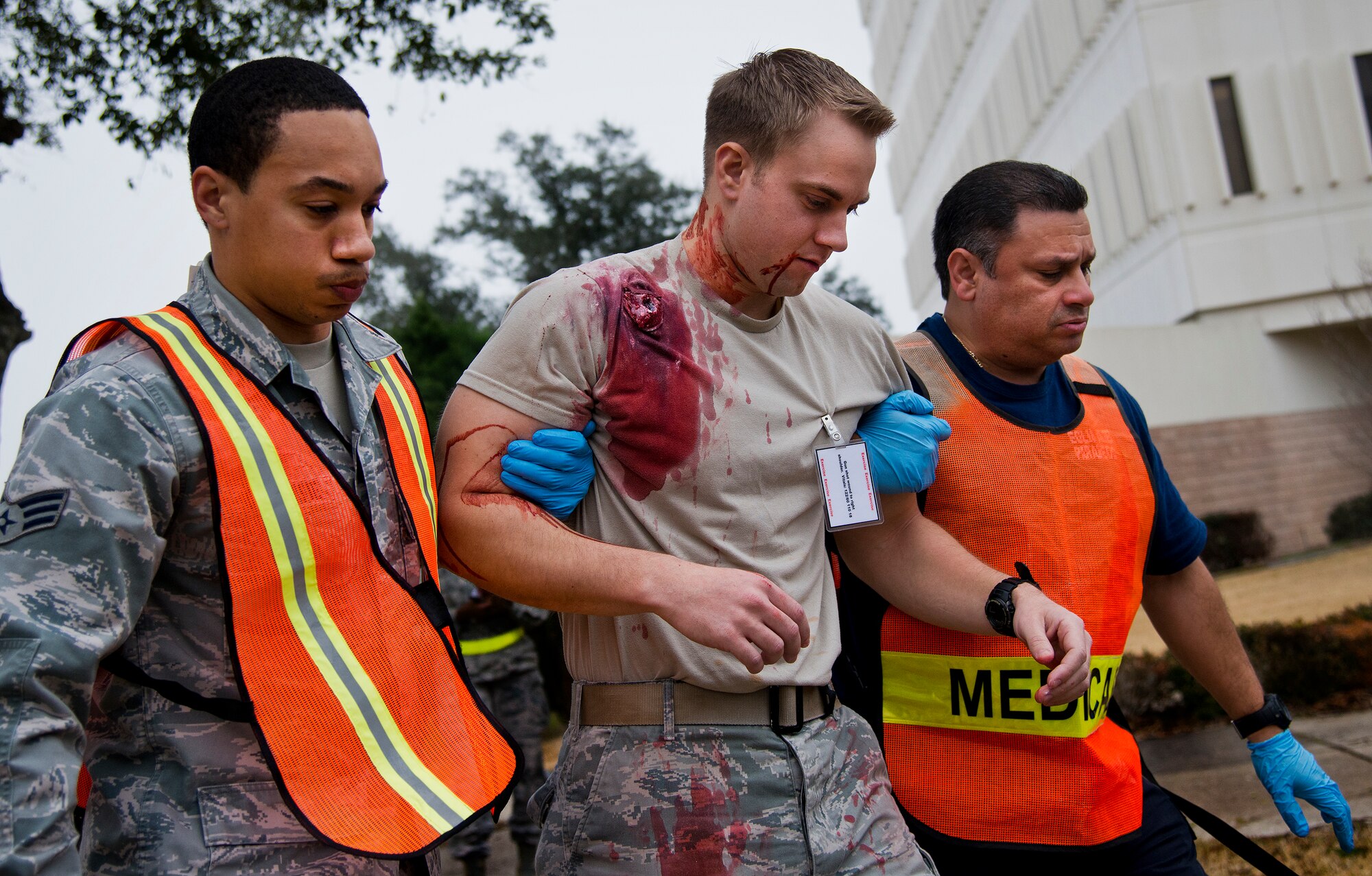 Emergency medical technicians from the 96th Medical Group move a wounded Airman toward safety during an active shooter exercise at Eglin Air Force Base, Fla., Feb. 4.  The active-shooter was the second of a series of 96th Test Wing exercises occurring all week.  (U.S. Air Force photo/Samuel King Jr.)