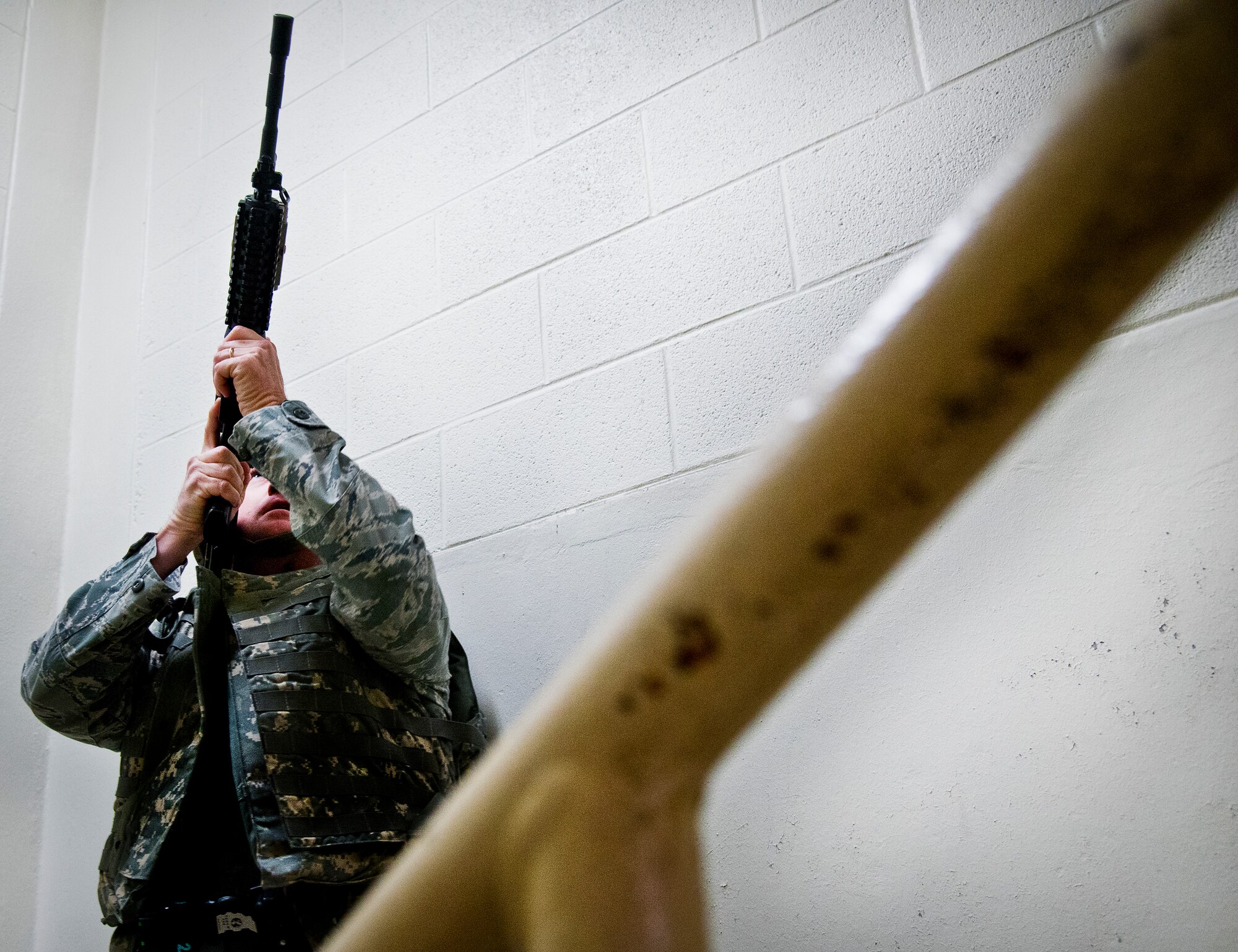 Tech. Sgt. Enoch Williams, of the 96th Security Forces Squadron, moves up the stairs toward an active-shooter scenario during an exercise at Eglin Air Force Base, Fla., Feb. 4.  Williams was the first responder on scene and entered the building to assess the situation.  Williams waited for back up before entering the floor where the 911 call came from.  The active-shooter was the second of a series of 96th Test Wing exercises occurring all week.  (U.S. Air Force photo/Samuel King Jr.)