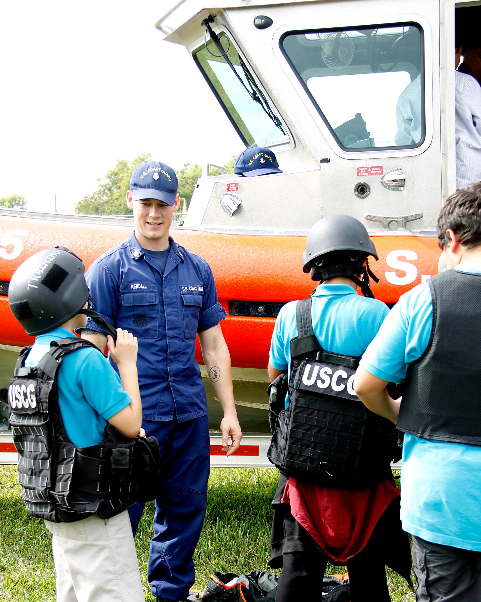 U.S. Coast Guard Petty Officer 1st Class Drew Kendall, administrative non-commissioned officer for Maritime Safety and Security Team Miami at Homestead Air Reserve Base, Fla., talks to students at Air Base K-8 Center in Homestead, Fla., about being in the Coast Guard on Jan. 31.  Students explored the different gear and got to climb in the 25-Foot Response Boat, Small Class that was brought out and used as a static display.  Truck Day is a way for the school to teach children about different careers available to them when they leave school so they can start thinking about what they want to do when they grow up. (U.S. Air Force photo by Senior Airman Jaimi L. Upthegrove)