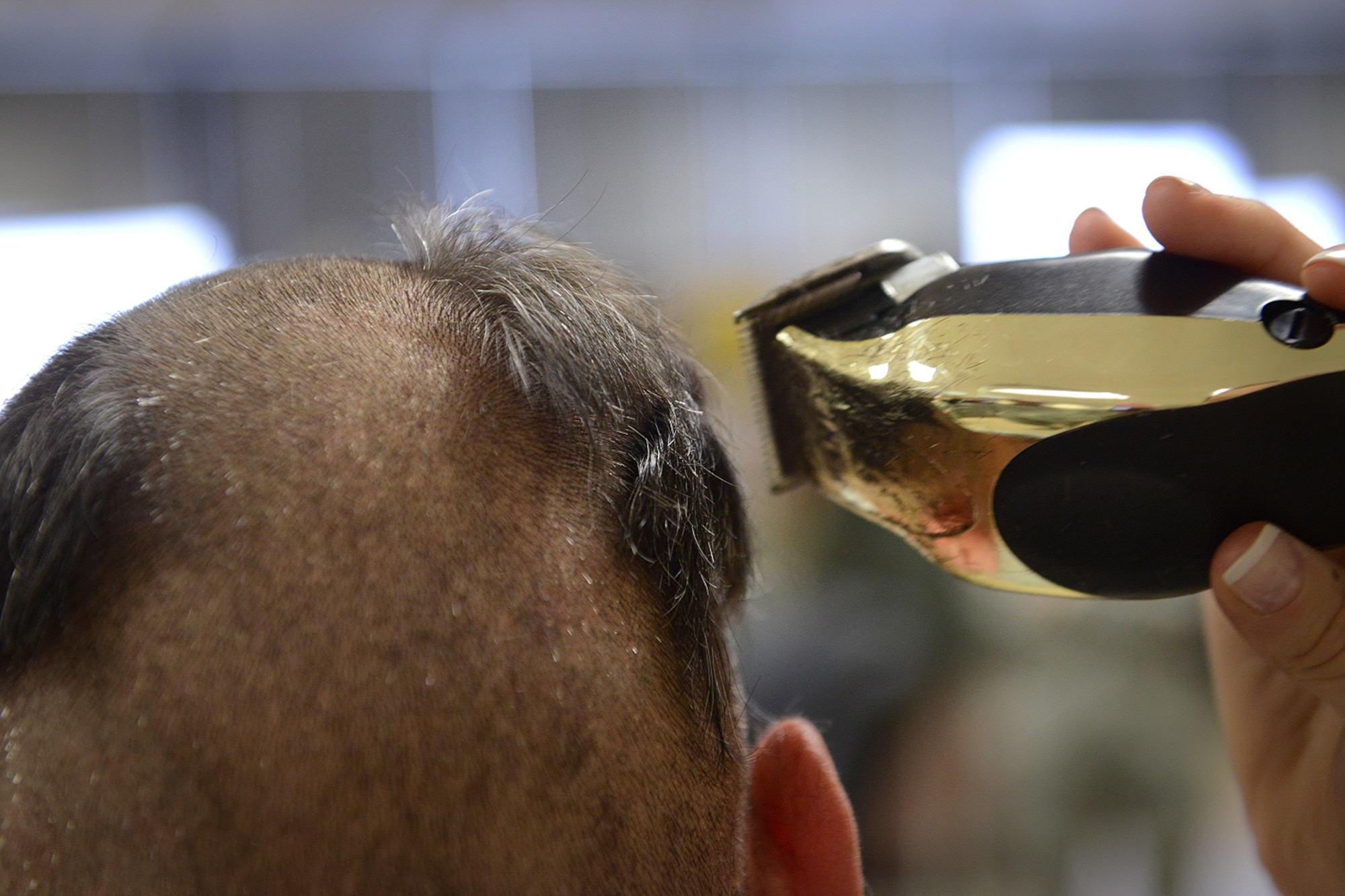 Chief Master Sergeant Dennis Dipiazzo, Chief of Cyber Communications, 138th Communication Flight, Tulsa Air National Guard, gets his hair cut off in preparation for getting his head shaved by members of his unit, Sunday, Feb. 2, 2014.    CMSgt Dipiazzo, challenged Comm Flight personnel to acquire 100% organizational membership in the National Guard Association of Oklahoma, if they could,  he would allow them to shave his head.  They accomplished the task in less than 48 hours.  ( U.S. National Guard photo by Senior Master Sgt.  Preston L. Chasteen/Released)