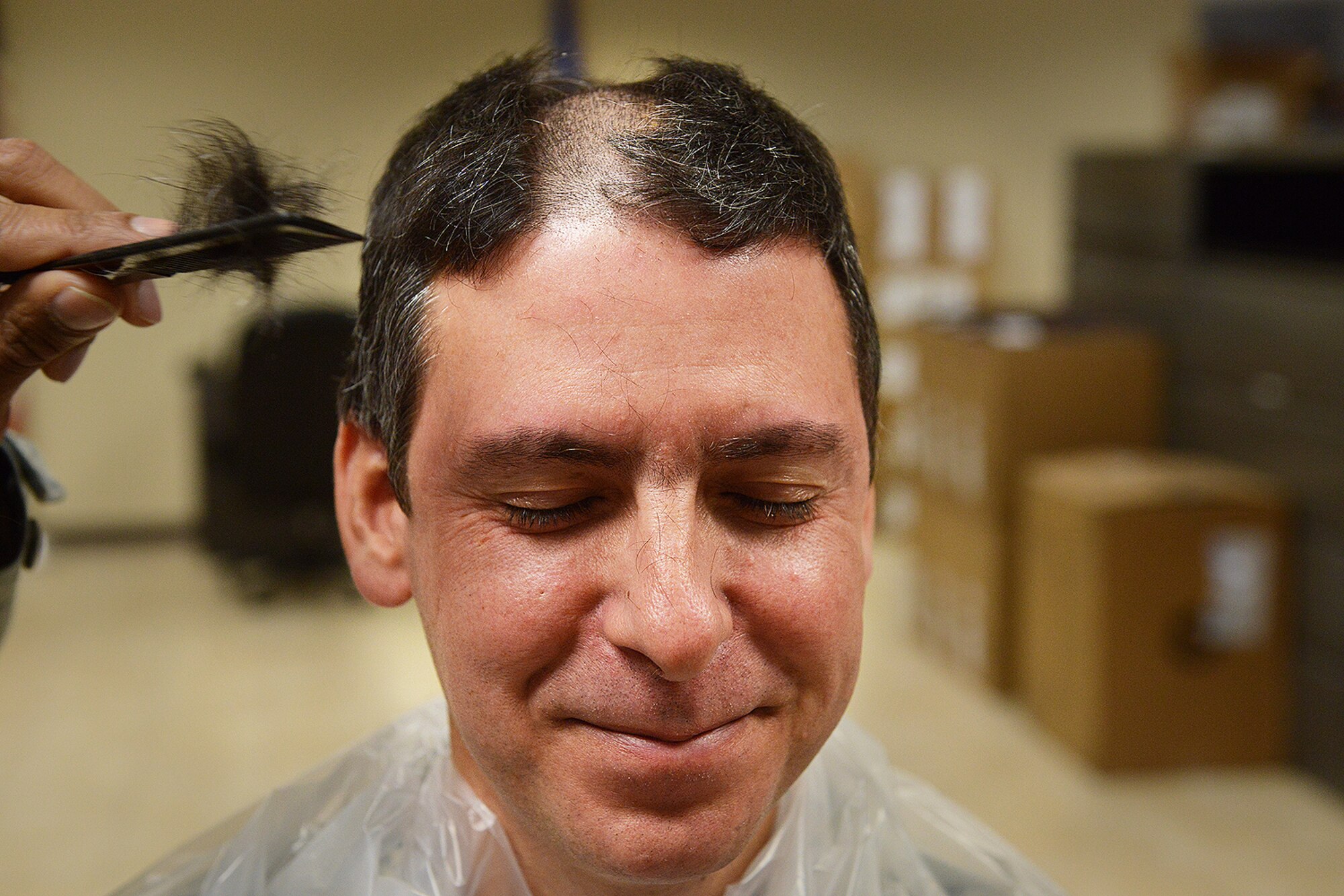 Chief Master Sergeant Dennis Dipiazzo, Chief of Cyber Communications, 138th Communication Flight, Tulsa Air National Guard, gets his hair cut off in preparation for getting his head shaved by members of his unit, Sunday, Feb. 2, 2014.    CMSgt Dipiazzo, challenged Comm Flight personnel to acquire 100% organizational membership in the National Guard Association of Oklahoma, if they could,  he would allow them to shave his head.  They accomplished the task in less than 48 hours.  ( U.S. National Guard photo by Senior Master Sgt.  Preston L. Chasteen/Released)