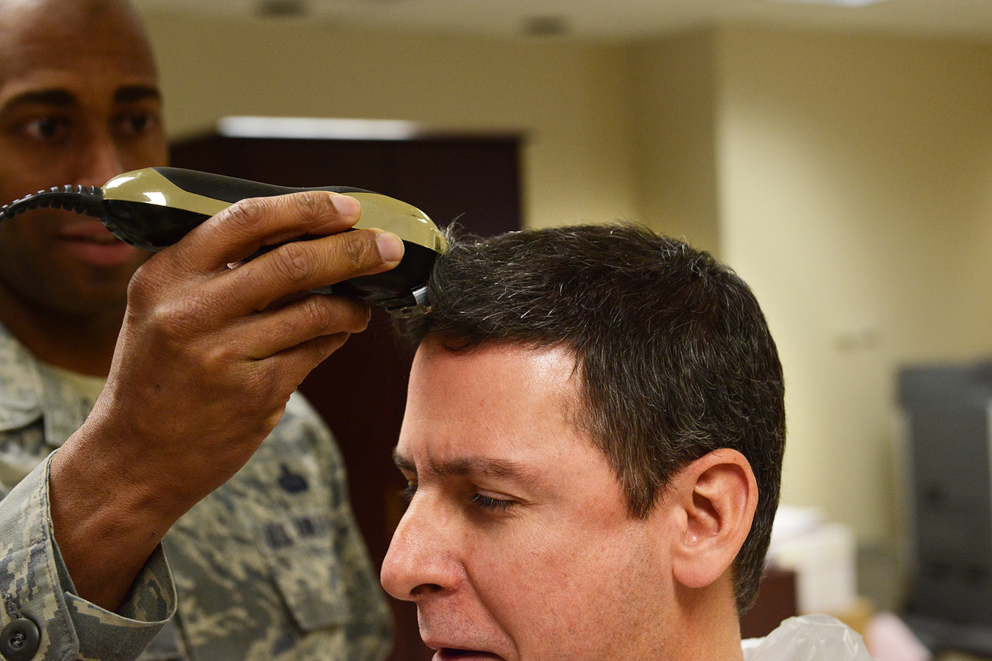 Chief Master Sergeant Dennis Dipiazzo, Chief of Cyber Communications, 138th Communication Flight, Tulsa Air National Guard, gets his hair cut off in preparation for getting his head shaved by members of his unit, Sunday, Feb. 2, 2014.    CMSgt Dipiazzo, challenged Comm Flight personnel to acquire 100% organizational membership in the National Guard Association of Oklahoma, if they could,  he would allow them to shave his head.  They accomplished the task in less than 48 hours.  ( U.S. National Guard photo by Senior Master Sgt.  Preston L. Chasteen/Released)