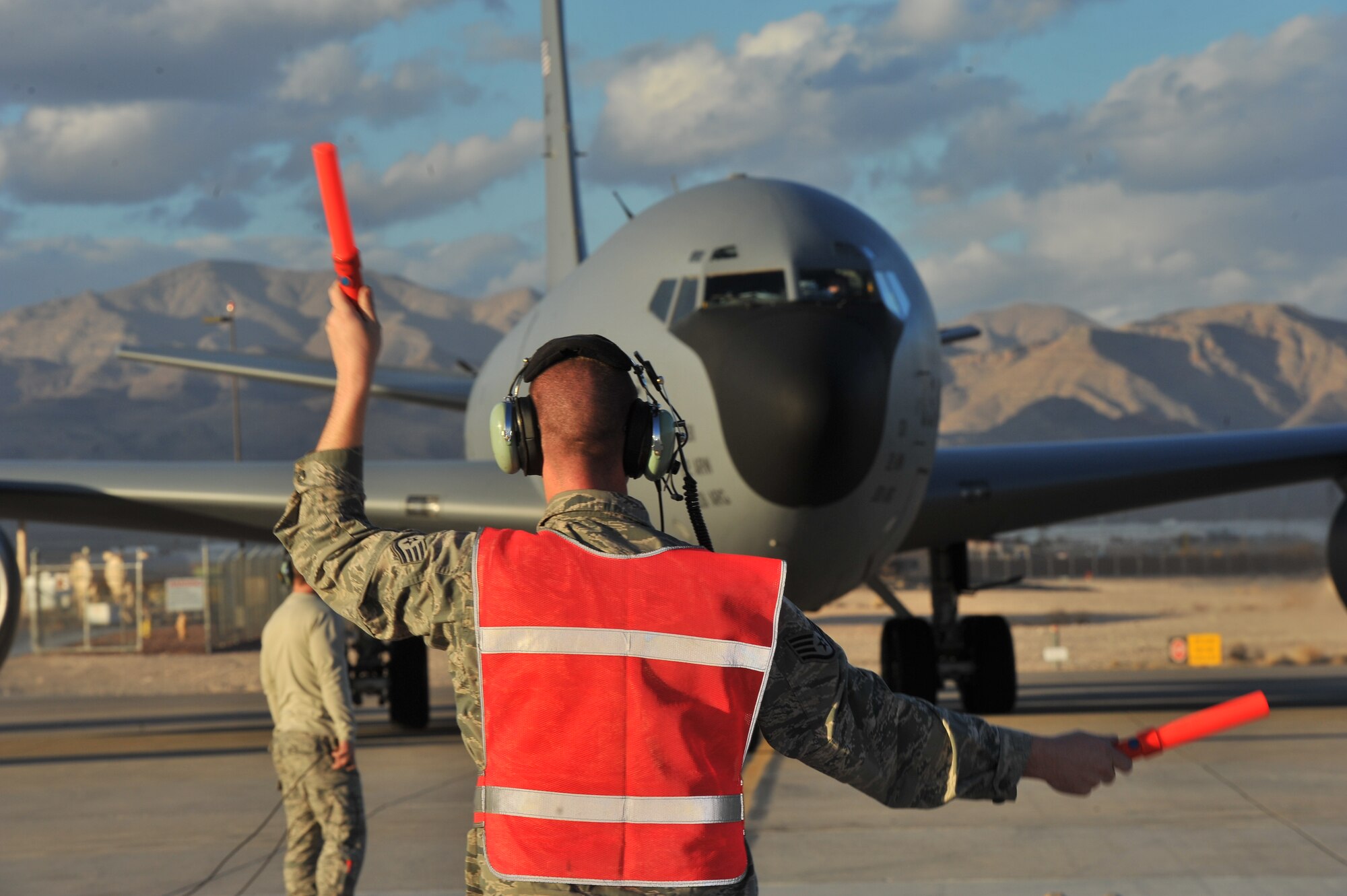 Staff Sgt. David Hendrickson, 92nd Aircraft Maintenance Squadron electronics and environmental journeyman, marshals in a KC-135 Stratotanker from Fairchild Air Force Base, Wash., after it landed at Nellis AFB, Nev., during Red Flag 14-1 Jan. 30, 2014. Red Flag gives service members from the U.S. and allied countries an opportunity to experience realistic combat scenarios to prepare and train them in the event of future conflicts or war. (U.S. Air Force photo by Staff Sgt. Veronica Montes)