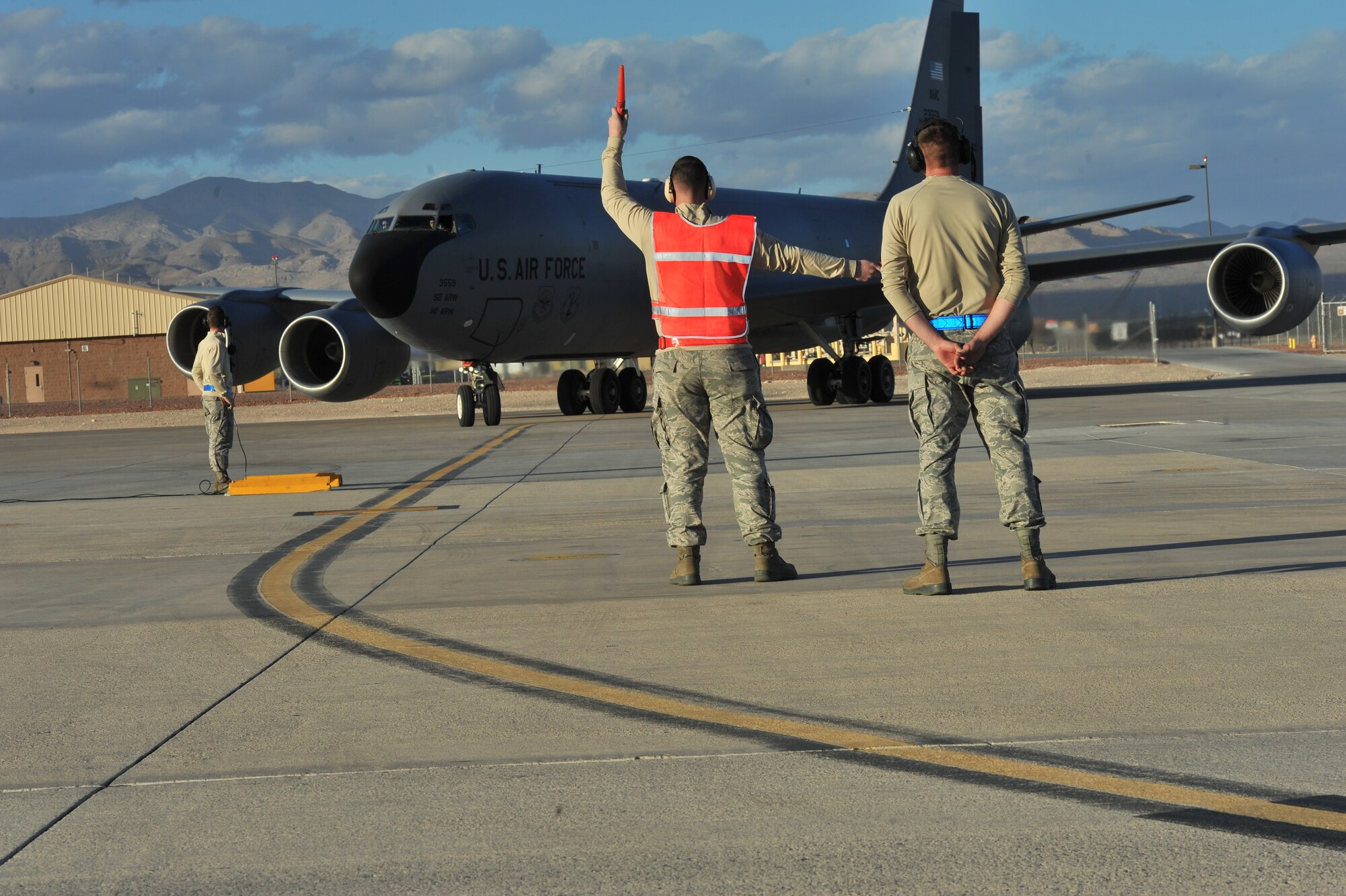 Airman 1st Class Abraham Vidulich, 22nd Maintenance Squadron aircraft metals technician, marshals in a KC-135 Stratotanker from Fairchild Air Force Base, Wash., after it landed at Nellis AFB, Nev., during Red Flag 14-1 Jan. 30, 2014. Red Flag was established in 1975 to better prepare Airmen for combat missions. (U.S. Air Force photo by Staff Sgt. Veronica Montes)
