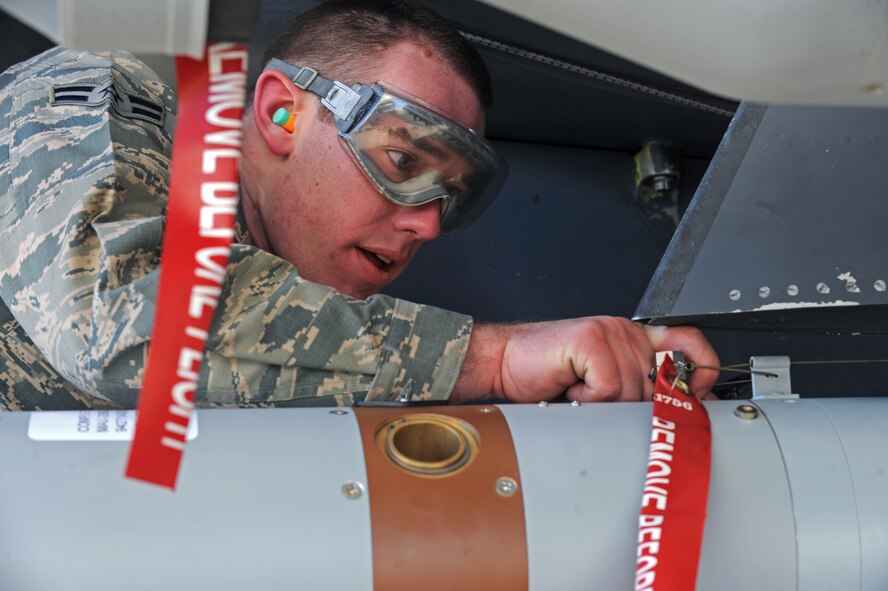 Airman 1st Class Hunter Leger, 4th Aircraft Maintenance Squadron load crew member, wires the Battery Firing Device (BFD) on a Guided Bomb Unit (GBU-12) laser guided bomb during a load crew of the quarter competition at Seymour Johnson Air Force Base, N.C., Jan. 24, 2013. The BFD initiates the process that allows the bomb to hit its designated target. (U.S. Air Force photo by Airman 1st Class Aaron J. Jenne)