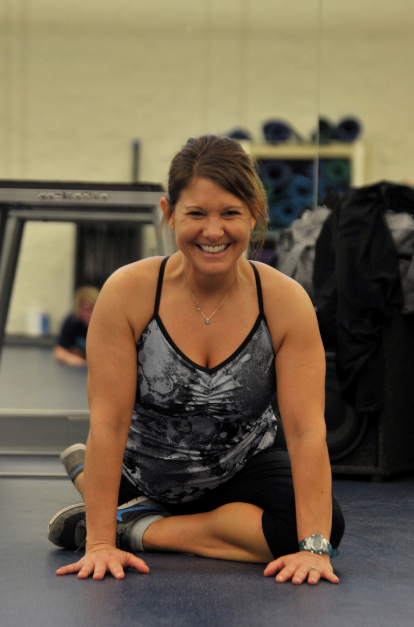 Nicole Larson, Aderholt Gym Kettlebell Fit instructor, demonstrates stretches after a workout at Hurlburt Field, Fla., Jan. 27, 2014. Larson has a master’s degree in exercise physiology. She said she worked as a teacher and strength and conditioning coach at a high school for seven years before coming to Hurlburt Field. (U.S. Air Force photo/Airman 1st Class Andrea Posey)