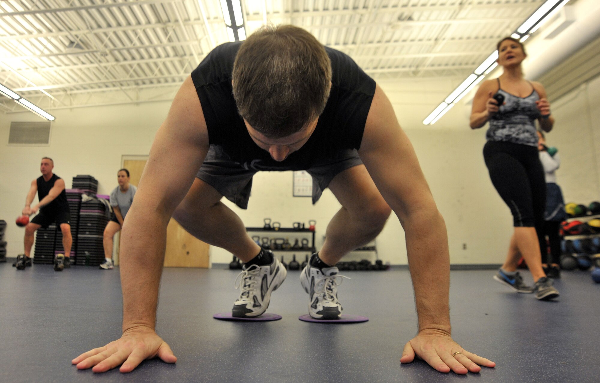 A Kettlebell Fit student performs modified mountain climbers at Hurlburt Field, Fla., Jan. 27, 2014. This exercise was part of the circuit-style workout. (U.S. Air Force photo/Airman 1st Class Andrea Posey)