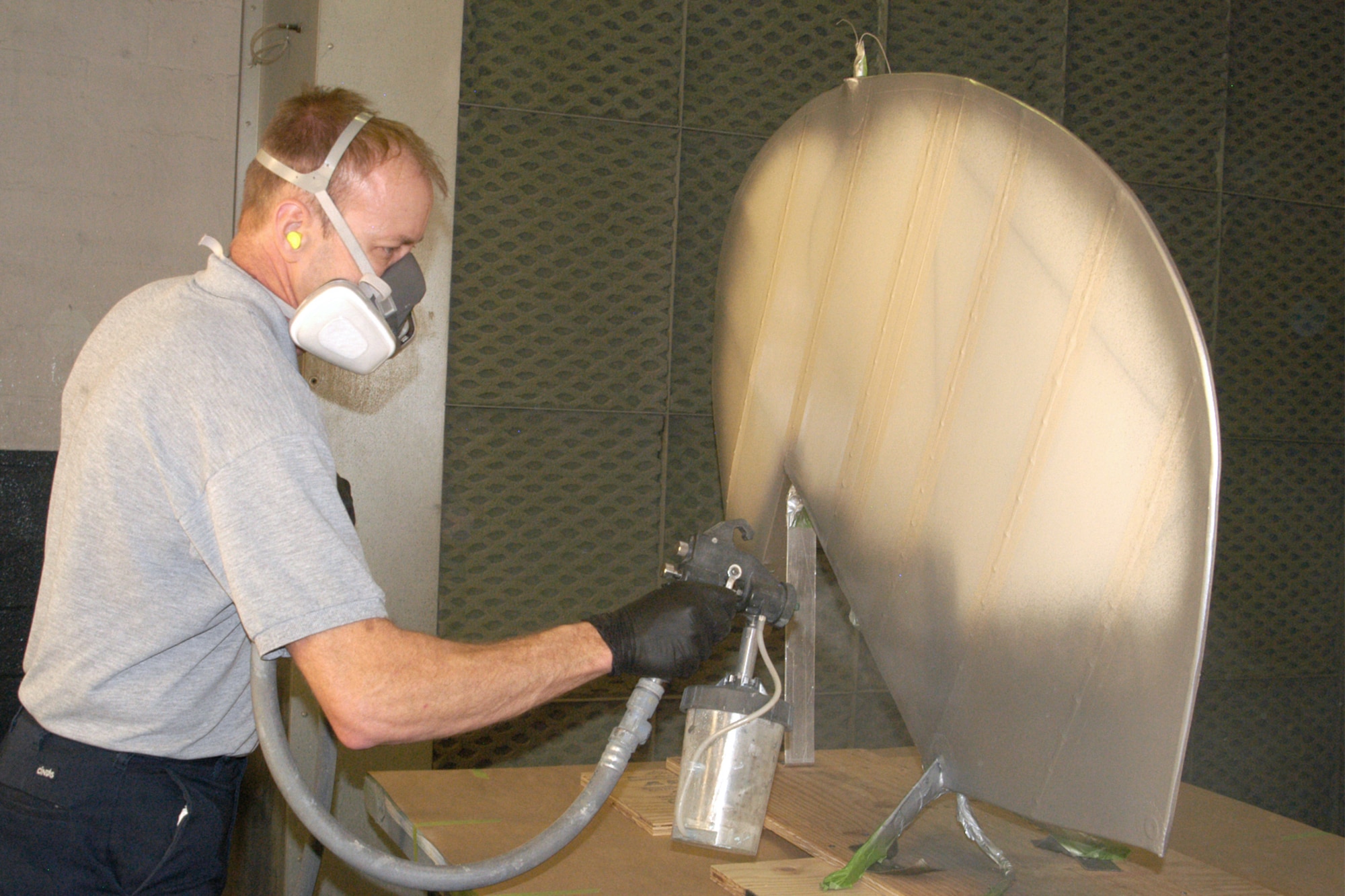 DAYTON,Ohio -- National Museum of the U.S. Air Force restoration specialist Brian Lindamood applies aluminized cellulose nitrate dope to a the Stearman PT-13D Kaydet. This paint serves as a UV protectant which keeps the fabric from deteriorating.  Plans call for the aircraft to be part of an expanded Tuskegee Airman exhibit in the World War II Gallery at the National Museum of the U.S. Air Force. (U.S. Air Force photo by Ken LaRock)