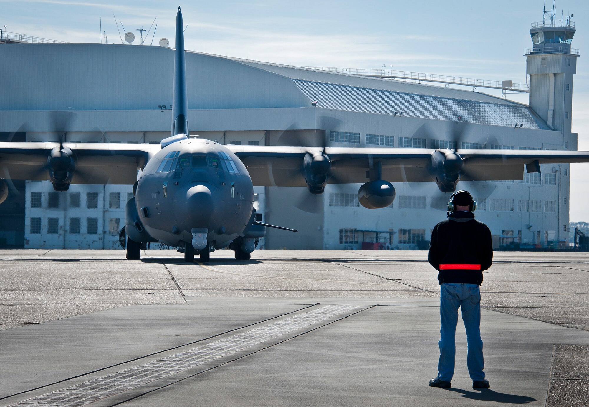 Dave King, of Lockheed Martin, prepares to marshal out the AC-130J Ghostrider for its first official sortie Jan. 31 at Eglin Air Force Base, Fla. The Air Force Special Operations Command MC-130J arrived at Eglin in January 2013 to begin the modification process for the AC-130J, whose primary mission is close air support, air interdiction and armed reconnaissance. A total of 32 MC-130J prototypes will be modified as part of a $2.4 billion AC-130J program to grow the future fleet. (U.S. Air Force photo/Chrissy Cuttita)