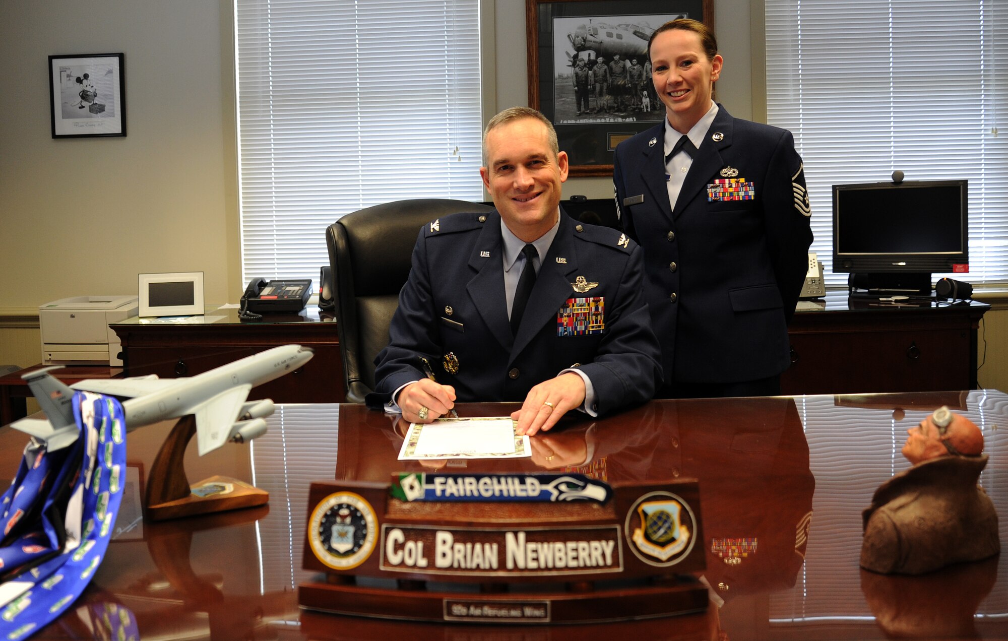 Col. Brian Newberry, 92nd Air Refueling Wing commander, poses for a picture with Master Sgt. Laurie Simons, Airman and Family Readiness Center superintendent, to proclaim the week of Feb. 24 through Feb. 28 as Military Saves Week at Fairchild Air Force Base, Wash., Jan. 31, 2014. Military Saves Week is a program to persuade, motivate and encourage military families to save money. (U.S. Air Force photo by Airman 1st Class Janelle Patiño/Released)