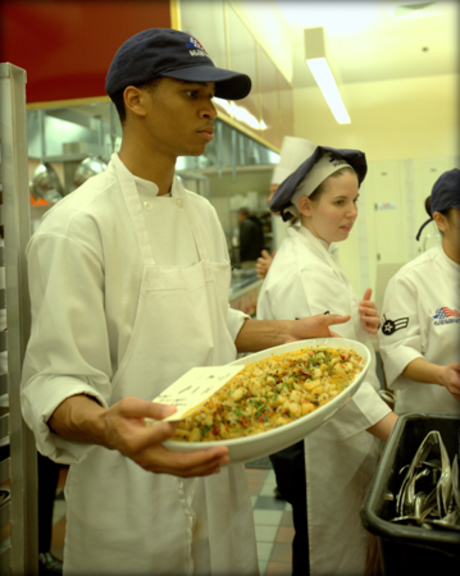Senior Airman Keith Smith displays a dish prepared by his team following a class exercise. Smith, a Reservist with the 908th Force Support Squadron, recently attended the Armed Forces Forum for Culinary Excellence at the Culinary Institute of America at Greystone in St. Helena, Calif. 
(Courtesy photo/National Restaurant Association © 2013 Celene Di Stasio)
