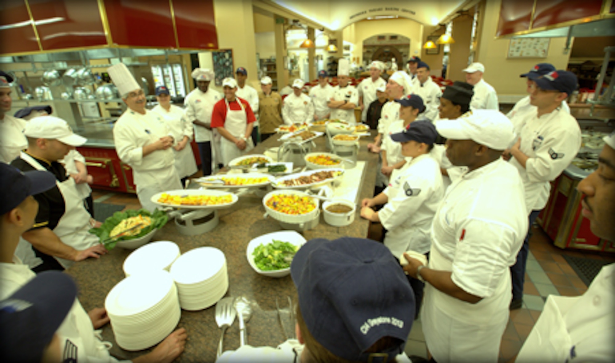 Senior Airman Keith Smith, just behind student in red shirt, and fellow students listen as a chef instructor gives a culinary skills class. Smith, a Reservist with the 908th Force Support Squadron, recently attended the Armed Forces Forum for Culinary Excellence at the Culinary Institute of America at Greystone in St. Helena, Calif. 
(Courtesy photo/National Restaurant Association © 2013 Celene Di Stasio)