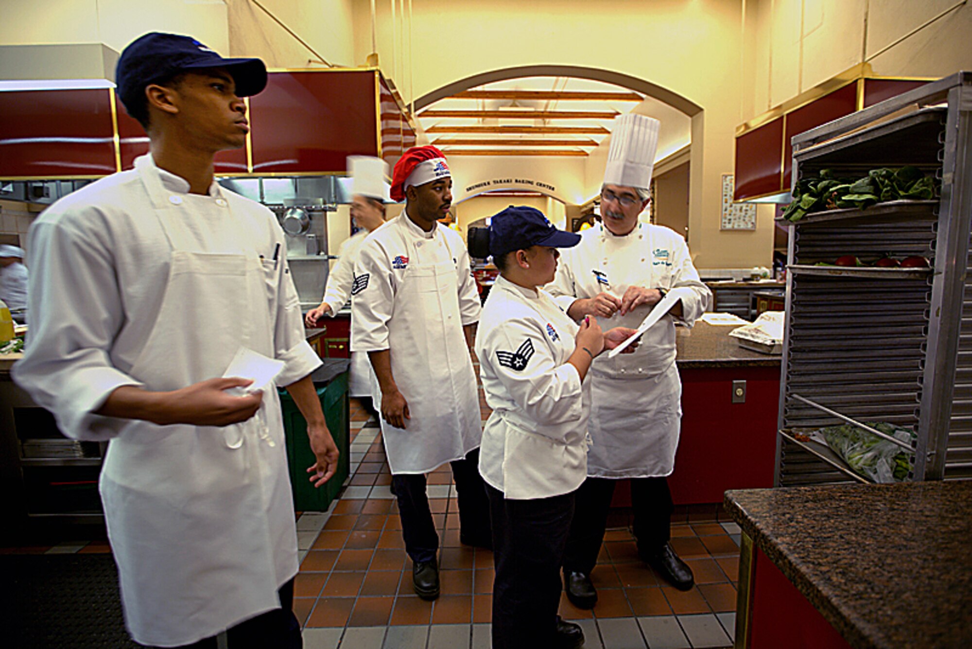 Senior Airman Keith Smith looks on as a chef instructor discusses techniques during a kitchen exercise. Smith, a Reservist with the 908th Force Support Squadron, recently attended the Armed Forces Forum for Culinary Excellence at the Culinary Institute of America at Greystone in St. Helena, Calif. 
(Courtesy photo/National Restaurant Association © 2013 Celene Di Stasio)