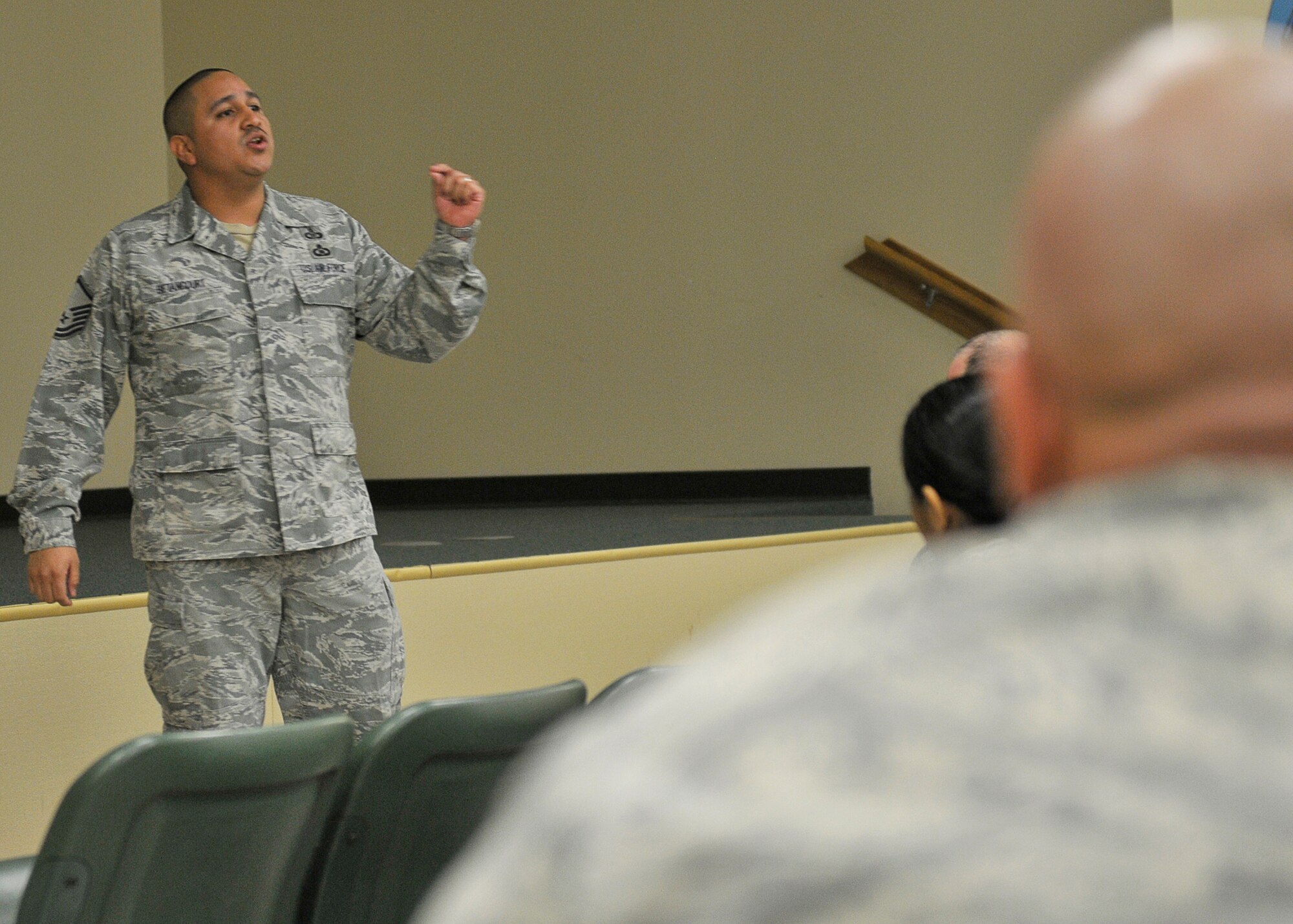 Master Sgt. Ricardo Betancourt, 601st Air Operations Center systems tester, gives a speech before commander’s call Jan. 24 at the Tyndall Red Horse auditorium. Betancourt tells the audience the need for skills in public speaking and leadership. (U.S. Air Force photo by Airman 1st Class Solomon Cook)