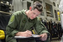 Staff Sgt. Ethan Hipple reviews maintenance records Feb. 3, 2014 for a dropped object event during a dual training and humanitarian aid mission. Hipple worked through the night at Key West Naval Air Station to fix the aircraft and keep it on schedule. Hipple is a flying crew chief with the 437th Aircraft Maintenance Squadron. (U.S. Air Force Photo/ Tech. Sgt. Shane Ellis)
