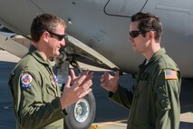 Maj. Rob McGrath and Staff Sgt. Ethan Hipple discuss details regarding a dropped object event during a dual training and humanitarian aid mission to Honduras. The coordinated efforts of McGrath and Hipple kept the mission on schedule. McGrath is an instructor pilot with the 701st Airlift Squadron and Hipple is a flying crew chief with the 437th Aircraft Maintenance Squadron. (U.S. Air Force Photo/Tech. Sgt. Shane Ellis)