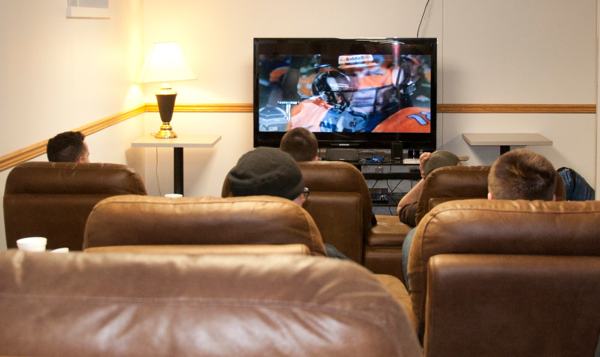 140202-F-GZ967-004 Airmen sit back in recliners as they watch the game on a big-screen television in the Airmen’s Oasis Feb. 2. (U.S. Air Force photo by Airman 1st Class Brandon Valle)
