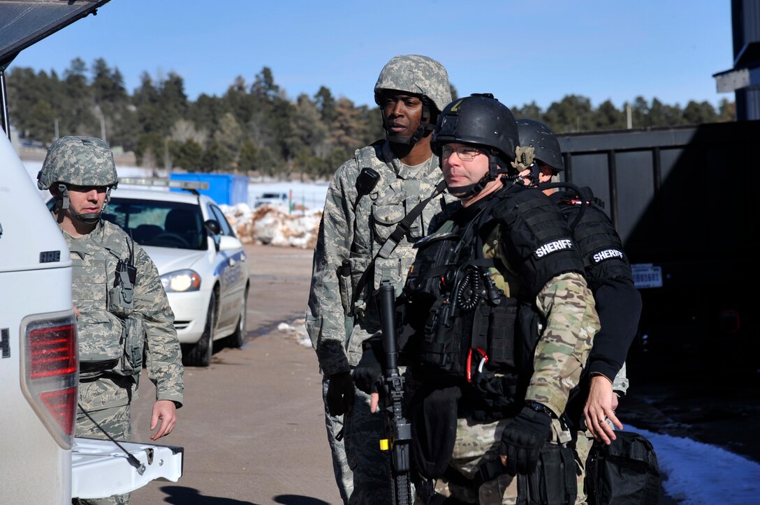 CHEYENNE MOUNTAIN AIR FORCE STATION, Colo. – First responders from the 21st Security Forces Squadron and El Paso County Sheriff's Office stand ready to act during a simulated hostage scenario during an exercise Jan. 29 at Cheyenne Mountain AFS. Condor Crest is designed to test and evaluate installation response to a real-world crisis or base wide situations that require command and control, first responder employment and cooperation with local law enforcement and community leaders. (U.S. Air Force photo/Robb Lingley)