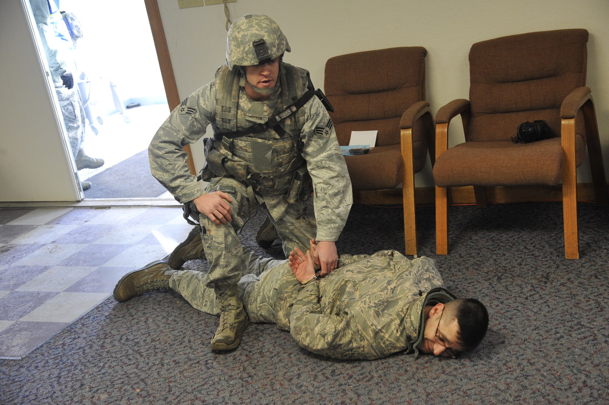 CHEYENNE MOUNTAIN AIR FORCE STATION, Colo. – An Airmen with the 21st Security Forces Squadron detains a suspected hostage taker at Cheyenne Mountain AFS during an emergency management exercise Jan. 29. Condor Crest is designed to test and evaluate installation response to a real-world crisis or base wide situation that requires command and control, first responder employment and cooperation with local law enforcement and community leaders. (U.S. Air Force photo/Robb Lingley)