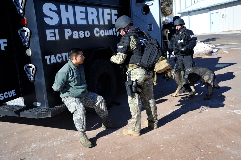 CHEYENNE MOUNTAIN AIR FORCE STATION, Colo. – Deputies from the El Paso County Sheriff's Office question a detained suspect during a simulated hostage scenario at Cheyenne Mountain AFS Jan. 29. Condor Crest is designed to test and evaluate installation response to a real-world crisis or base wide situation that requires command and control, first responder employment and cooperation with local law enforcement and community leaders. (U.S. Air Force photo/Robb Lingley)
