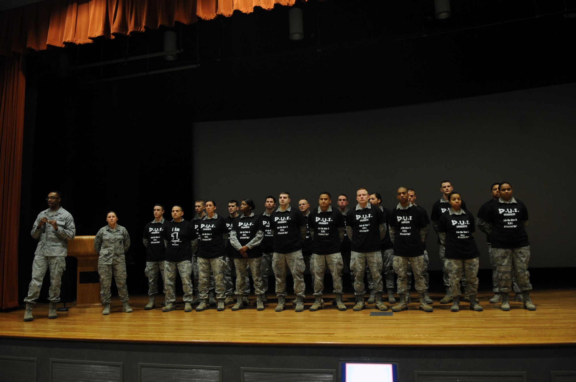 U.S. Air Force Airmen stand on stage during a driving under the influence awareness campaign commander’s call, Jan. 31, 2014 at Dyess Air Force Base, Texas. During an exercise Jan. 30, it was simulated that these Airmen were killed by drunk drivers. All Airmen under the age of 26 attended the commander’s call, where representatives from the Abilene Sheriff’s Department and Mothers Against Drunk Driving spoke about the effects of drinking and driving. (U.S. Air Force photo by Senior Airman Shannon Hall/Released)