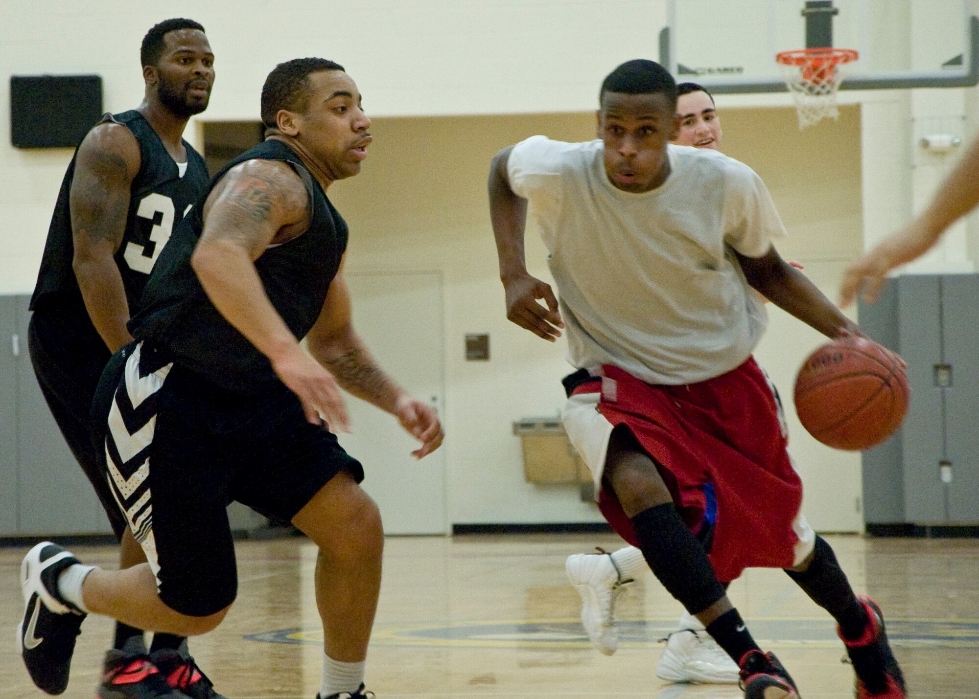 Ricco Jones, 436th Aircraft Maintenance Squadron guard, drives hard toward the basket Jan. 30, 2014, during an intramural basketball game at the fitness center on Dover Air Force Base, Del. Jones scored 12 points to help the 436th AMXS stay unbeaten with a 66-42 victory against the 436th Airlift Wing/Comptroller Squadron. (U.S. Air Force photo/Senior Airman Jared Duhon)