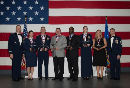Col. Darren Hartford, 437th Airlift Wing commander (left), and Chief Master Sgt. Shawn Hughes, 437th Airlift Wing command chief (right), and the 437th AW Annual Award winners gather after the 437th AW Annual Awards Banquet at the USS Yorktown, Jan. 31, 2014 in Charleston, S.C. (Left to right) Airman 1st Class Laura Reed, 437th Airlift Wing 14th Airlift Squadron, Capt. David Rhodes, 437th Aircraft Maintenance Squadron, John Speaks, 437th Maintenance Squadron, Archie Evans 437th AW 16 AS,  Staff Sgt. Keitha McCarthy, 437th Airlift Wing command chief executive, and Tonya Prentiss, wife of Capt. Christopher Prentiss, 437th Operations Group. Not pictured are Senior Master Sgt. Terrence Spradley, 437th MXS and MSgt Eric Rainer, 437th AW 15 AS. (U.S. Air Force photo/ Senior Airman Ashlee Galloway)