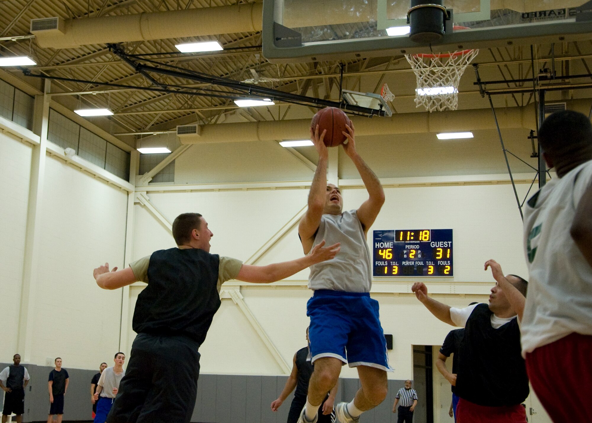 Raul Rodgriguez, 436th Aircraft Maintenance Squadron player-coach, puts up a shot after an offensive rebound Jan. 30, 2014, during an intramural basketball game at the fitness center on Dover Air Force Base, Del. The 436th AMXS dominated the boards in its 66-42 victory against the 436th Airlift Wing/Comptroller Squadron. (U.S. Air Force photo/Senior Airman Jared Duhon)