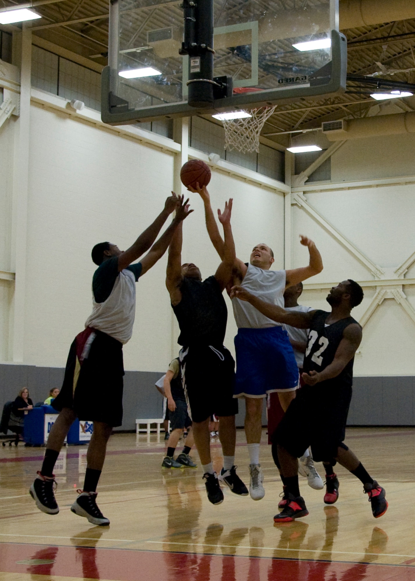 Raul Rodriguez, 436th Aircraft Maintenance Squadron player-coach, fights to score a basket Jan. 30, 2014, during an intramural basketball game at the fitness center on Dover Air Force Base, Del. Rodriguez finished with a game-high of 17 points in the 66-42 victory against the 436th Airlift Wing/Comptroller Squadron. (U.S. Air Force photo/Senior Airman Jared Duhon)