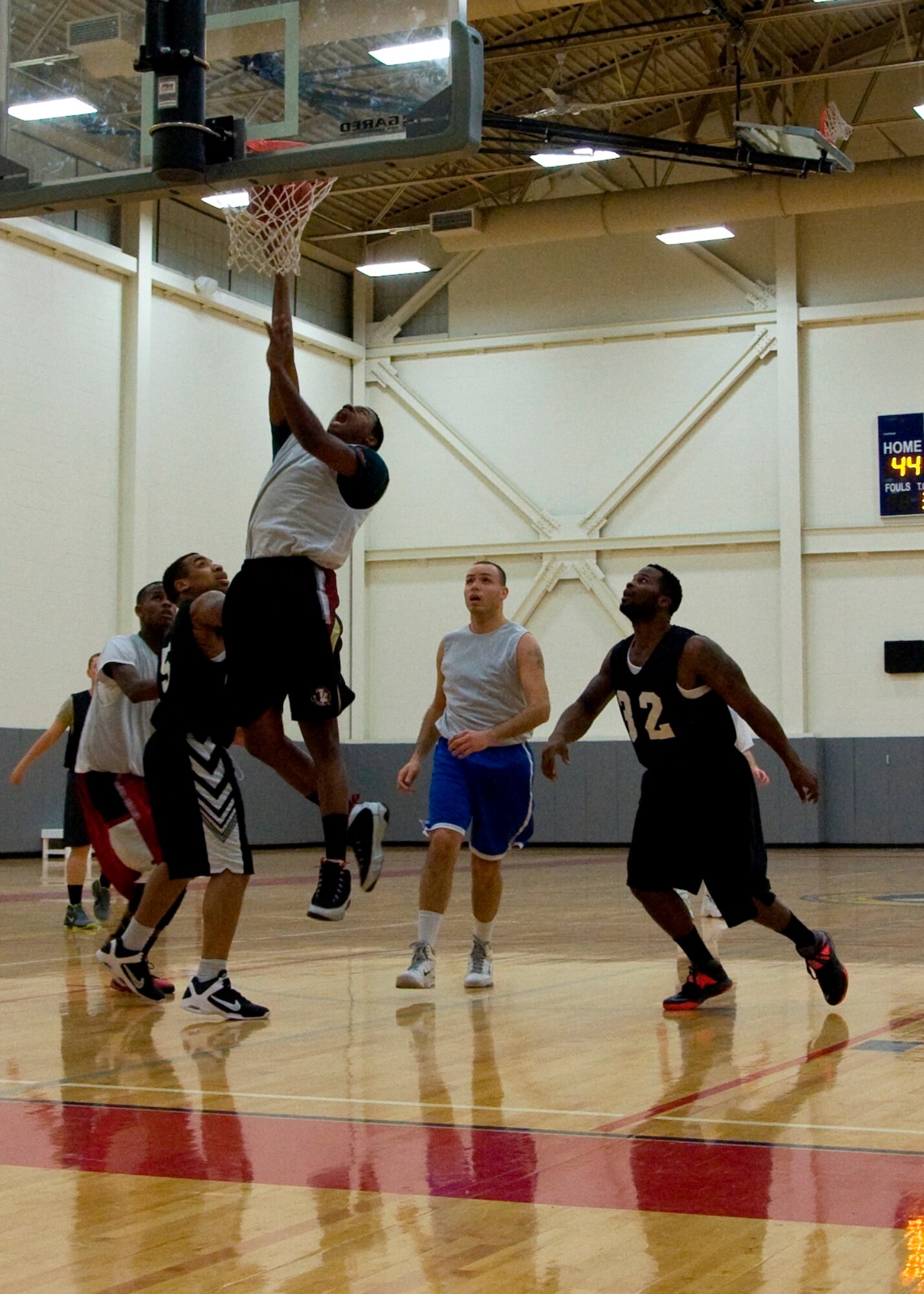 Stephon Nelson, 436th Aircraft Maintenance Squadron forward, drives for a layup during an intramural basketball game Jan. 30, 2014, at the fitness center on Dover Air Force Base, Del. Nelson scored six points as the 436th AMXS defeated the 436th Airlift Wing/Comptroller Squadron 66-42. (U.S. Air Force photo/Senior Airman Jared Duhon)