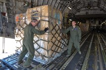 Humanitarian aid being offloaded from a Charleston based C-17 Globemaster III by Master Sgt. Tom House (left) and Tech. Josh Fugle from the 701st Airlift Squadron.  The donated humanitarian aid was delivered to Panama and Honduras. (U.S. Air Force Photo/Maj. Wayne Capps)