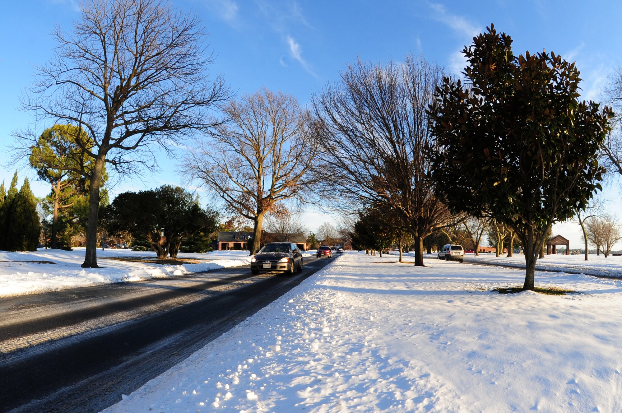 Cars drive on Hammond Avenue at Langley Air Force Base, Va., Jan. 30, 2014. The 633rd Civil Engineer Squaron plowed the roads of Langley AFB, allowing members access to continue carrying out its mission. (U.S. Air Force photo by Airman 1st Class Areca T. Wilson/Released) 