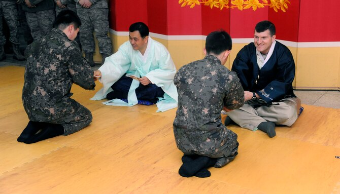 Col. S. Clinton Hinote, 8th Fighter Wing commander, and Col. Song Ho Jung, Republic of Korea air force 38th Fighter Group commander, participate in a time-honored bowing tradition as part of the Lunar New Year celebration at Kunsan Air Base, Republic of Korea, Feb. 1, 2014. U.S. and ROKAF Airmen came together to celebrate the new year by participating in a traditional bowing ceremony, eating Korean cuisine and playing a variety of games. (U.S. Air Force photo by Staff Sgt. Jessica Haas) 