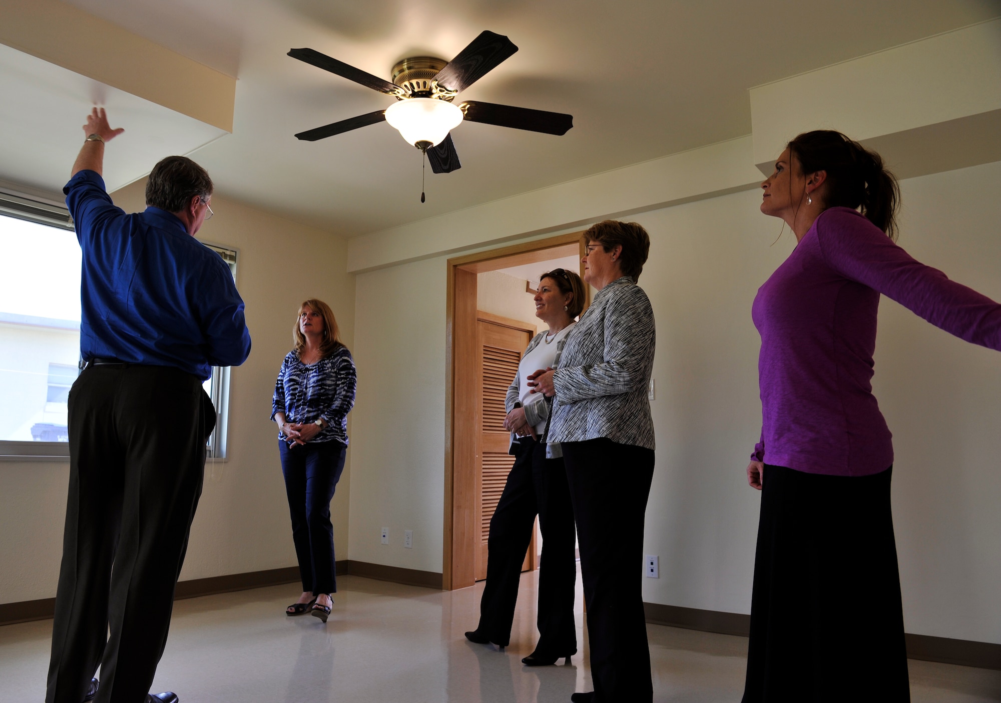 Mark Pinnau, 718th Civil Engineer Squadron deputy commander, explains about the Okinawa housing redevelopment plan to Cindy Scaparrotti, wife of U.S. Army Gen. Curtis Scaparrotti, and spouses of 18th Wing leadership during a visit to Kadena Air Base, Japan, Jan. 30, 2014. The 718th CES manages military family housing and also oversees all renovations as well as housing improvement on island. (U.S. Air Force photo by Naoto Anazawa)