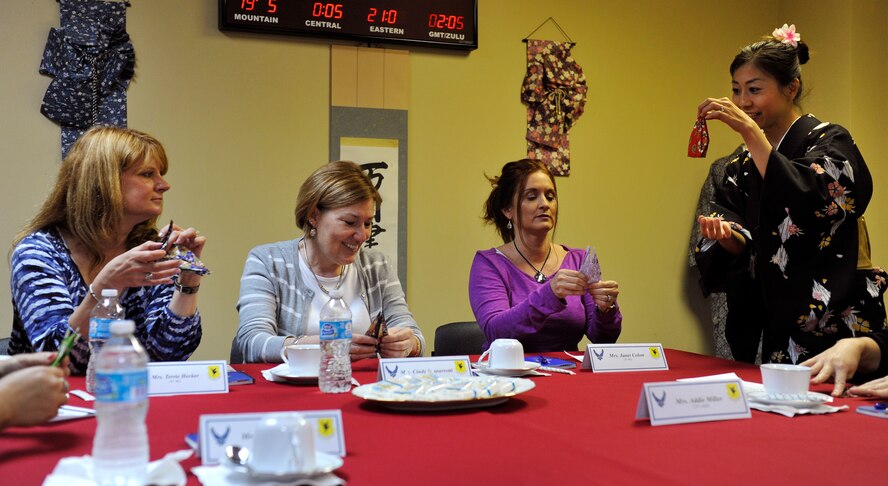 Nanako Misato, 18th Force Support Squadron inter-cultural coordinator, shows Cindy Scaparrotti, wife of U.S. Army Gen. Curtis Scaparrotti, and spouses of 18th Wing leadership how to make a crane in origami (Japanese paper) at the Airman and Family Readiness Center during a visit to Kadena Air Base, Japan, Jan. 30, 2014. At the AFRC, Cindy and spouses of 18th Wing leadership learned about their mission, readiness programs, cultural awareness, and enjoyed learning about Okinawan cultures as well. (U.S. Air Force photo by Naoto Anazawa)