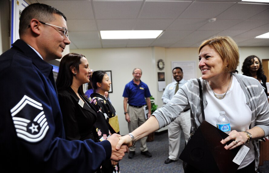 U.S. Air Force Senior Master Sgt. Ryan Fondulis, 18th Force Support Squadron NCO in charge, shakes hands with Cindy Scaparrotti, wife of U.S. Army Gen. Curtis Scaparrotti, during a visit to Kadena Air Base, Japan, Jan. 30, 2014. Cindy came from United States Forces Korea and learned the way Airman and Family Readiness Center operates here. (U.S. Air Force photo by Naoto Anazawa)

