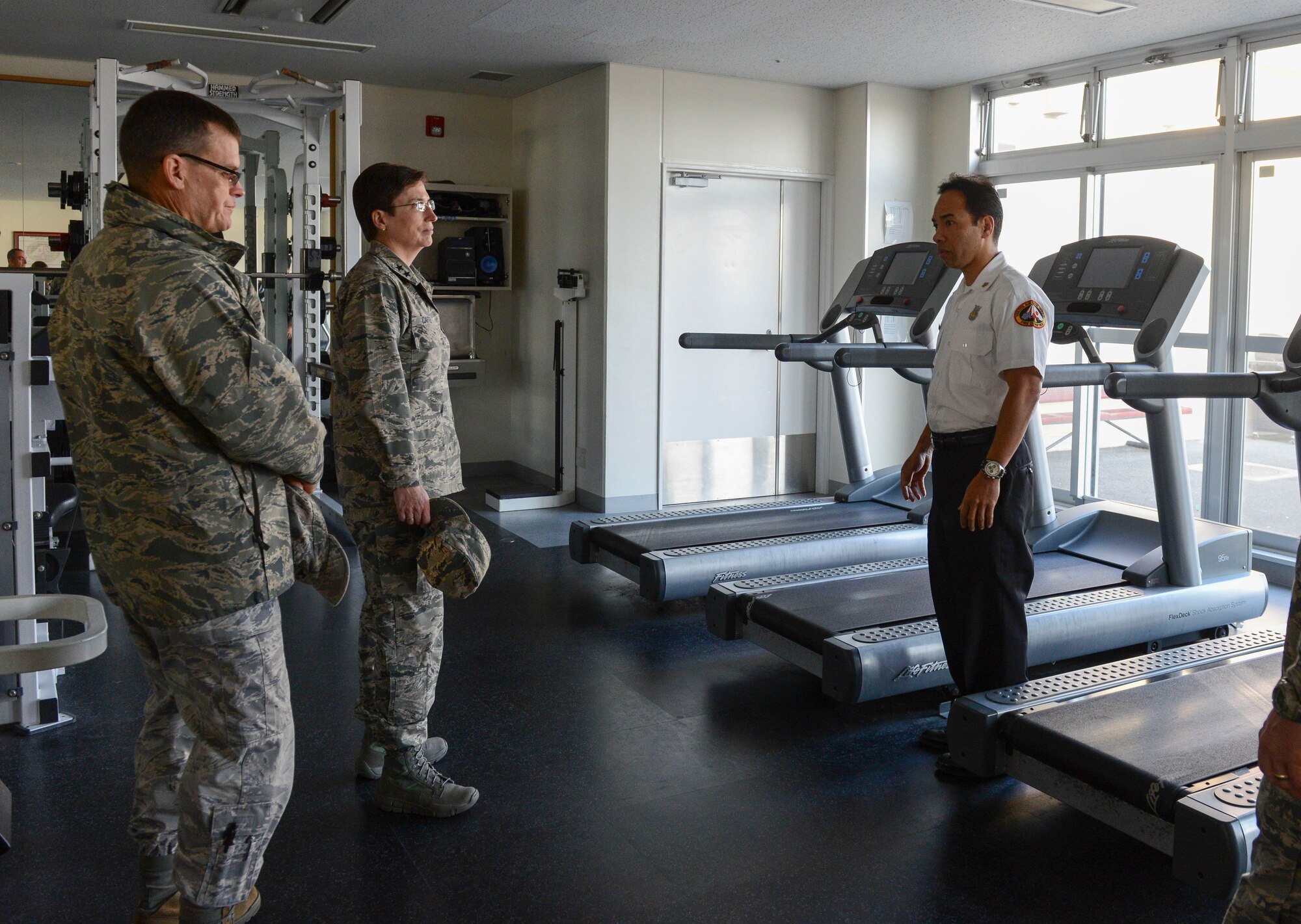 Maj. Gen. Theresa Carter, Air Force Civil Engineer, Deputy of Staff For Logistics, Installations and Mission Support, speaks with Fire Chief Reynold Mateo at Yokota Air Base, Japan, Jan.23, 2014. Throughout the day, Carter met with members of the 374th CES to become more familiar with many current programs and daily operations on base. (U.S. Air Force photo by Airman 1st Class Meagan Schutter/Released)