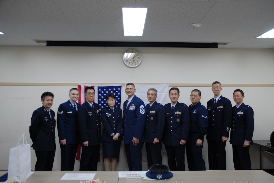 Chief Master Sgt. Manuel Roblesreynoso, 374th Airlift Wing command chief and two US Airmen, poses for a group photo with members of Japan Air Self-Defense Forces at Iruma Air Base, Japan, Jan. 30, 2014.  (Courtesy Photo)