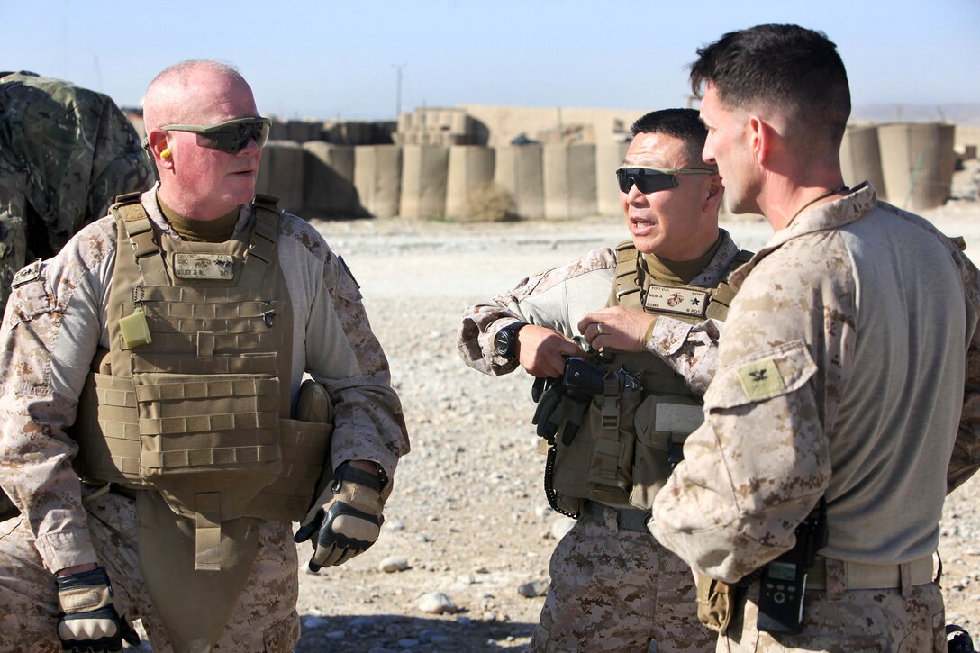 U.S. Marine Corps Maj. Gen. Walter Lee Miller Jr., left, commanding general of Regional Command Southwest, and U.S. Marine Corps Brig. Gen. Daniel D. Yoo, center, commanding general of the 1st Marine Expeditionary Force, discuss an operation with U.S. Marine Corps Col. Christopher Douglas, right, team leader for  Security Force Assistance Advisor Team 2-215, at an Afghan army base near Forward Operating Base Nolay in Afghanistan's Helmand province, Jan. 28, 2014.