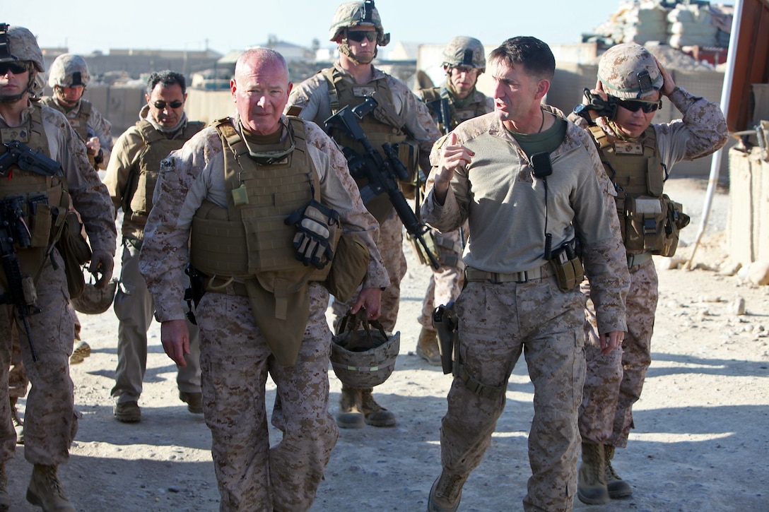 U.S. Marine Corps Maj. Gen. Walter Lee Miller Jr., left, commanding general of Regional Command Southwest, walks with U.S. Marine Corps Col. Christopher Douglas, team leader for  Security Force Assistance Advisor Team 2-215, during a visit to an Afghan army base near Forward Operating Base Nolay in Afghanistan's Helmand province, Jan. 28, 2014. U.S. Marine Corps Brig. Gen. Daniel D. Yoo, right, is commanding general of the 1st Marine Expeditionary Force.