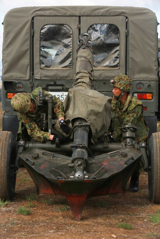 Soldiers from the Japan Ground Self-Defense Force unhitch a 120mm mortar system from a vehicle during Exercise Iron Fist 2014 aboard Camp Pendleton, Calif., Feb. 3, 2014.  Iron Fist 2014 is an amphibious exercise that brings together Marines and sailors from the 15th Marine Expeditionary Unit, other I Marine Expeditionary Force units, and soldiers from the JGSDF, to promote military interoperability and hone individual and small-unit skills through challenging, complex and realistic training. (U.S. Marine Corps photo by Sgt. Jamean R. Berry/Released)
