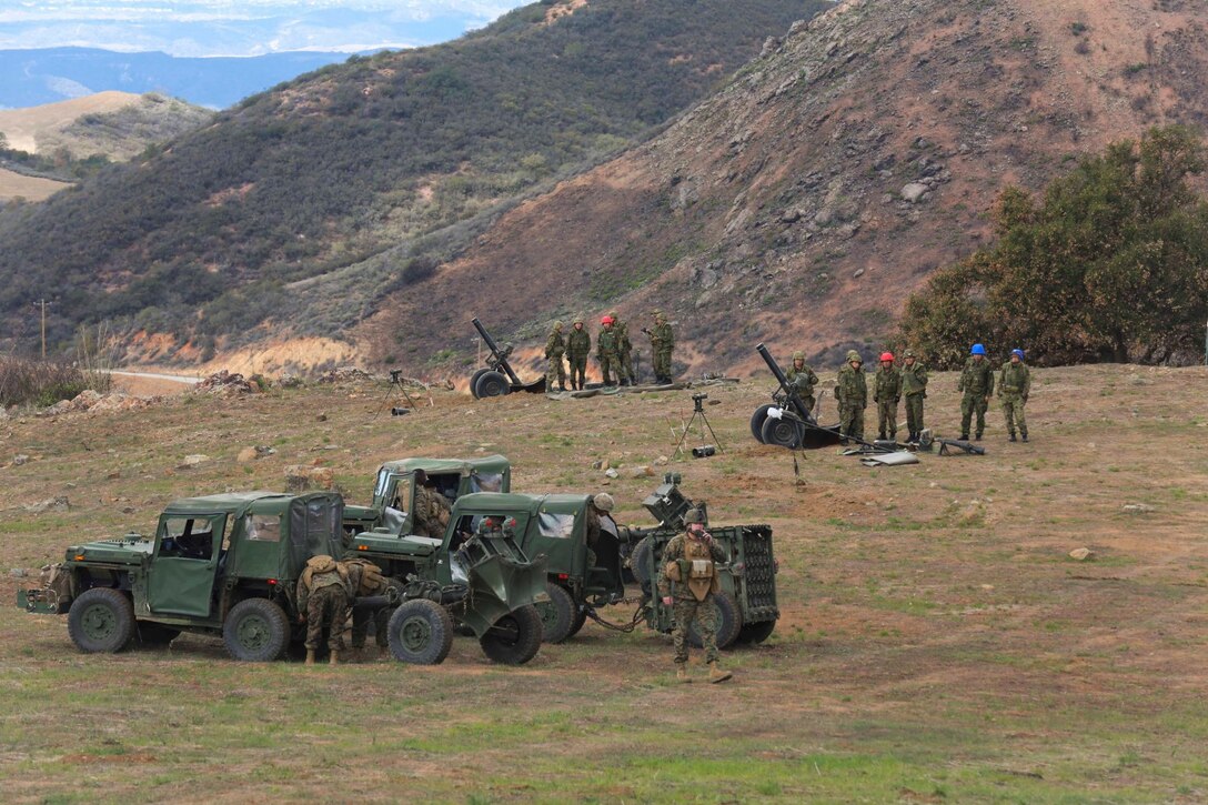 U.S. Marines and soldiers from the Japan Ground Self-Defense Force set up 120mm mortar systems in firing positions during Exercise Iron Fist 2014 aboard Camp Pendleton, Calif., Feb. 3, 2014.  Iron Fist 2014 is an amphibious exercise that brings together Marines and sailors from the 15th Marine Expeditionary Unit, other I Marine Expeditionary Force units, and soldiers from the JGSDF, to promote military interoperability and hone individual and small-unit skills through challenging, complex and realistic training. (U.S. Marine Corps photo by Sgt. Jamean R. Berry/Released)