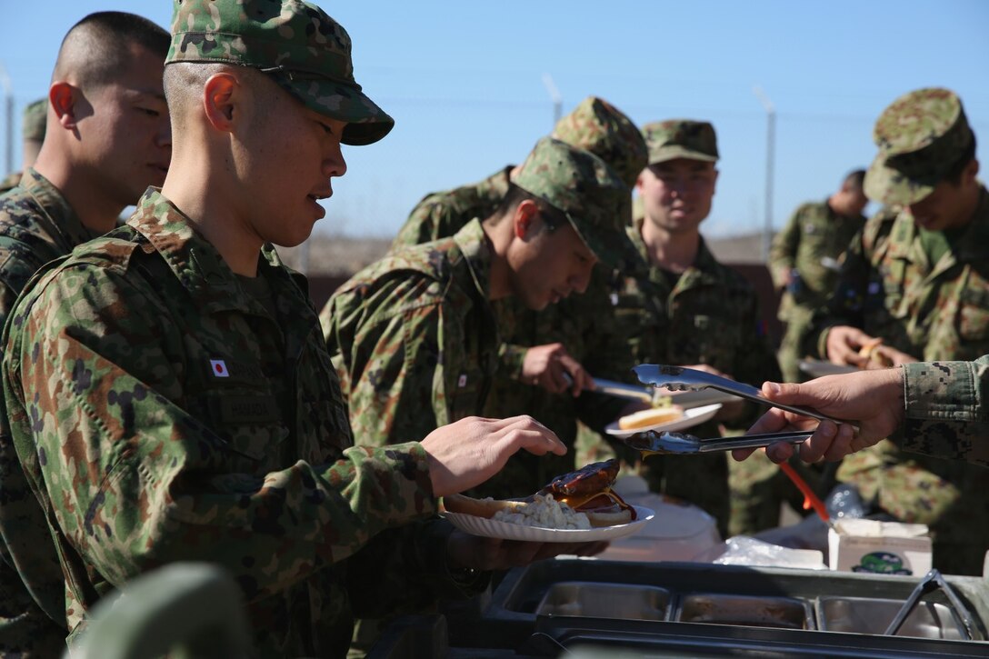 U.S. Marines with 1st Air Naval Gunfire Liaison Company eat lunch with soldiers from the Japan Ground Self-Defense Force during Exercise Iron Fist 2014 aboard Camp Pendleton, Calif., Feb. 3, 2014. Iron Fist 2014 is an amphibious exercise that brings together Marines and sailors from the 15th Marine Expeditionary Unit, other I Marine Expeditionary Force units, and soldiers from the JGSDF, to promote military interoperability and hone individual and small-unit skills through challenging, complex and realistic training. (U.S. Marine Corps photo by Lance Cpl. Anna K. Albrecht/Released)
