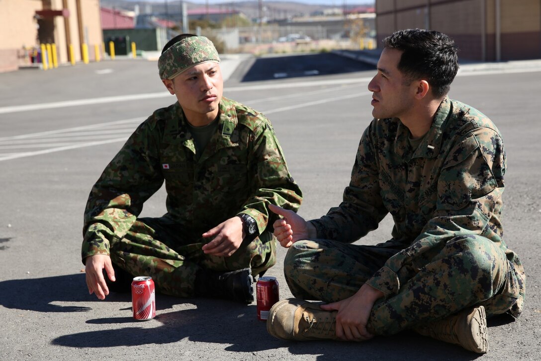 U.S. Marine 2nd Lt. Justin Seignemartin, right, Japanese translator, 15th Marine Expeditionary Unit, sits with a soldier from the Japan Ground Self-Defense Force during Exercise Iron Fist 2014 aboard Camp Penldeton, Calif., Feb. 3, 2014. Iron Fist 2014 is an amphibious exercise that brings together Marines and sailors from the 15th MEU, other I Marine Expeditionary Force units, and soldiers from the JGSDF, to promote military interoperability and hone individual and small-unit skills through challenging, complex and realistic training. (U.S. Marine Corps photo by Lance Cpl. Anna K. Albrecht/Released)