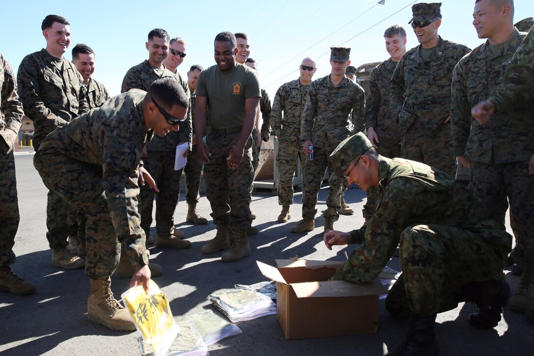 Soldiers from the Japan Ground Self-Defense Force give gifts to U.S. Marines with 1st Air Naval Gunfire Liaison Company during Exercise Iron Fist 2014 aboard Camp Pendleton, Calif., Feb. 3, 2014. Iron Fist 2014 is an amphibious exercise that brings together Marines and sailors from the 15th Marine Expeditionary Unit, other I Marine Expeditionary Force units, and soldiers from the JGSDF, to promote military interoperability and hone individual and small-unit skills through challenging, complex and realistic training. (U.S. Marine Corps photo by Lance Cpl. Anna K. Albrecht/Released)