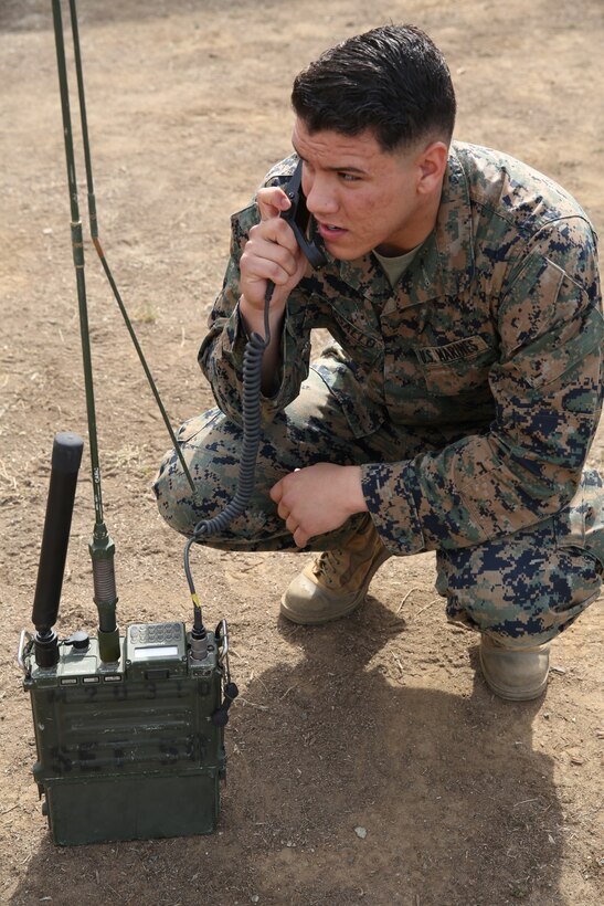 U.S. Marine Lance Cpl. Carlos Vassallo, field radio operator, 15th Marine Expeditionary Unit, conducts radio checks with soldiers from the Japan Ground Self-Defense Force during Exercise Iron Fist 2014 aboard Camp Pendleton, Calif., Feb. 4, 2014. Iron Fist 2014 is an amphibious exercise that brings together Marines and sailors from the 15th MEU, other I Marine Expeditionary Force units, and soldiers from the JGSDF, to promote military interoperability and hone individual and small-unit skills through challenging, complex and realistic training. (U.S. Marine Corps photo by Lance Cpl. Anna K. Albrecht/Released)